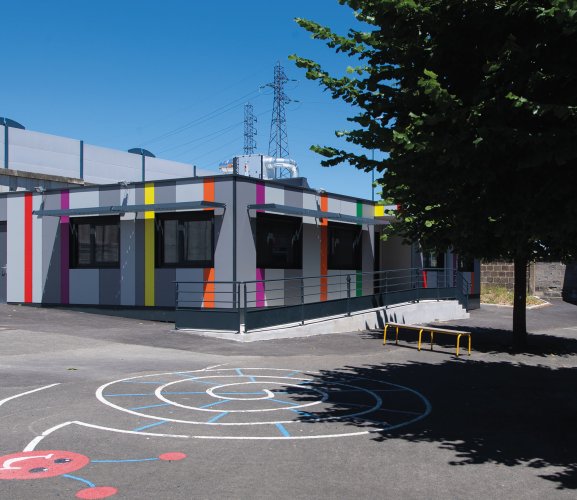 cour de l’école primaire de Chanteranne à Clermont Ferrand avec vue sur la salle de classe modulaire colorée